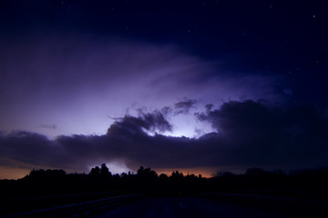 Fototapeta premium night sky with distant lightning storm and stars