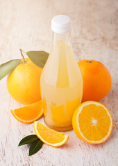 Glass  bottle of fresh mandarin tangerine juice