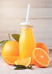 Fototapeta na wymiar Glass bottle of raw organic fresh orange juice