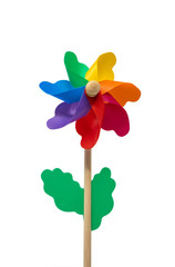 A Catherine wheel wind (pinwheel) isolated on white background. Colors: green, yellow, blue, purple, fuchsia, orange, red. Child's toy made of plastic curls attached to a wooden stick. Like a flower.