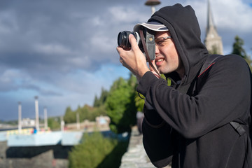 young man with a camera photographer photoshoot focus shooting looking outdoor session person model discover explorer world earth view see click press course lesson teach class 