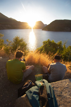 couple of photographers at sunset taking pictures images idea explorer discover adventure magic hour golden sunlight bright course lesson daylight outdoor lake mountain travel hill people river 