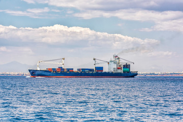 the ship is a container ship sailing along the sea