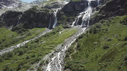 Aerial view of mountain landscape. Aerial view of mountains covered forest, trees with flowing river, against the sky and clouds