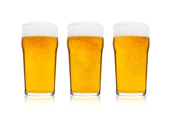 Cold glasses of lager beer with foam and dew