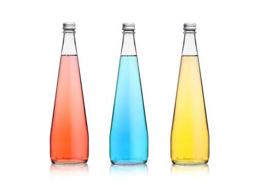 Glass bottles of sparkling pink blue soda lemonade