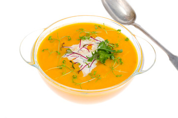 Vegetable cream soup with young green sprouts isolated on white background.