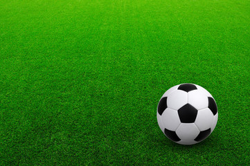 Soccer ball on green football field