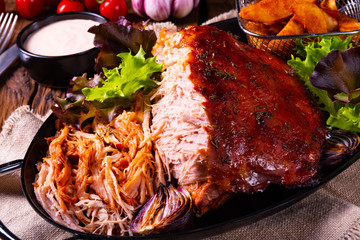 delicious pulled pork with baked potato quarters