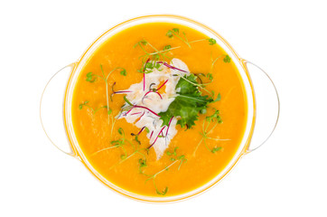 Vegetable cream soup with young green sprouts isolated on white background.