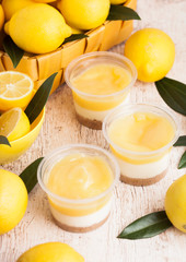 Plastic cups with lemon cream and biscuit dessert