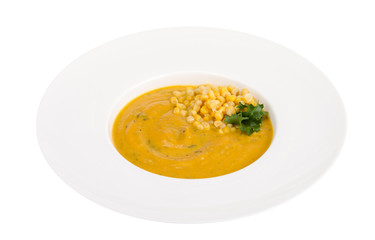 White plate with corn mash soup