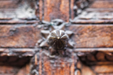 Wood cross design with metal spike in the center