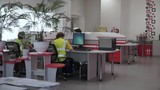 Rear view of a group of multiethnic office industrial workers using computers. Clip