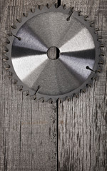 Circular saw on wooden background
