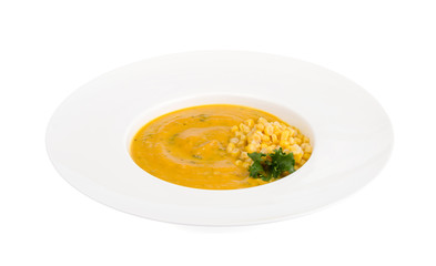 White plate with corn mash soup