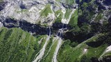 Flight over the Altai mountains. Stunning waterfall aerial view. Waterfall flows into the river