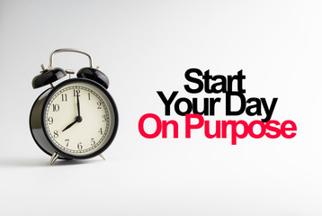 START YOUR DAY ON PURPOSE inscription written and alarm clock on white background. Business and motivation concept