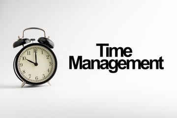 TIME MANAGEMENT inscription written and alarm clock on white background. Business and motivation concept