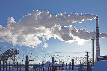Environmental pollution. Smoke from pipes in winter. The concept of the fight against pollution.