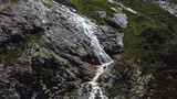 Close-up raging mountain waterfalls. Aerial view of giant waterfall flowing in mountains