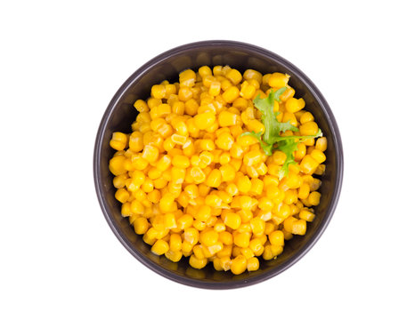 Canned corn in black bowl.