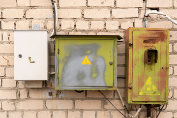 Electric boxes on the brick wall