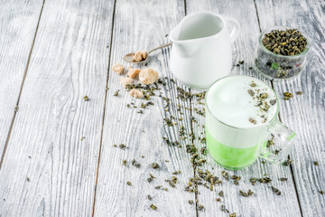 Tea latte, Hot Tokyo Fog Tea Drink with Foamed Milk and Matcha, wooden background copy space