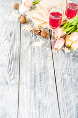 Pesah celebration concept. jewish Passover holiday background with matzo, eggs, spring flowers, wine, green background copy space top view