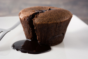 Coulant chocolate cake on wooden table