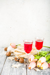 Pesah celebration concept. jewish Passover holiday background with matzo, eggs, spring flowers, wine, green background copy space top view