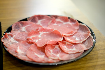 Sliced meat on a plate ready for Sukiyaki or Shabu shabu