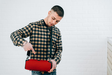a young guy with a portable sound system for music working via Bluetooth
