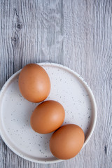 Top view of eggs on a white plate