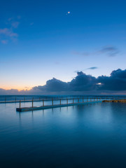 Dawn blue hour view of South Curl Curl rock pool.