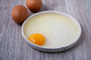 Yolk and eggs on a wooden background