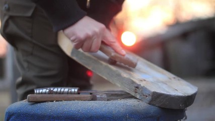 man cleans the board with a metal brush