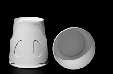white paper cup on black background