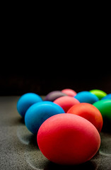 Variety of painted Easter eggs on black background