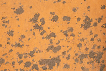 Cement stains on yellow and orange plaster texture. The abstract pattern from blot cement on orange and yellow background wall. 