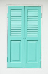 blue wood door on white wall