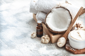 still life with coconut oil in a bottle and fresh coconut