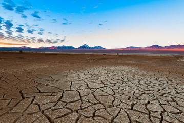 Cracked earth and Licancabur volcano at the Atacama Desert.