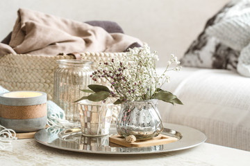 Home decorations in the interior. A turquoise blanket and wicker basket with a vase of flowers and...