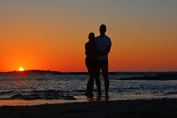 Fototapeta na wymiar A couple on the background of a sunset
