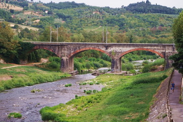 Fototapeta na wymiar Railway bridge over Sieve river, Pontassieve, Tuscany, Italy