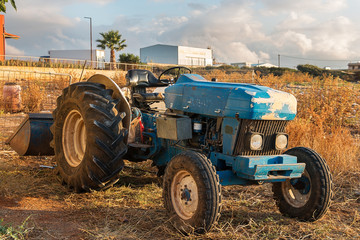An old tractor is in the field.