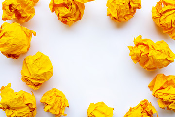 Yellow crumpled paper ball isolated on white