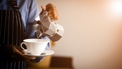 Barista making Espresso,  Americano, Cappuccino, Latte, Mocha, and preparing coffee drink.