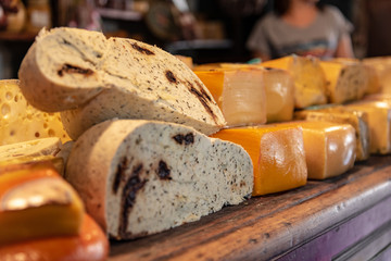 Different sort of cheeses on a wooden board for sale